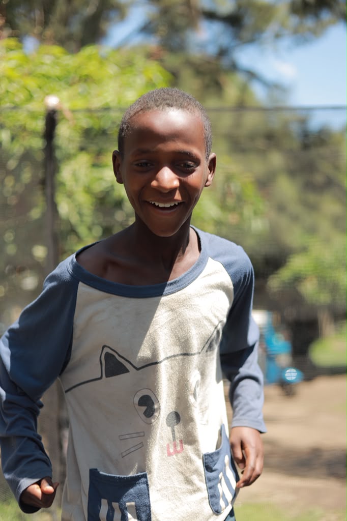 Boy smiling outdoors