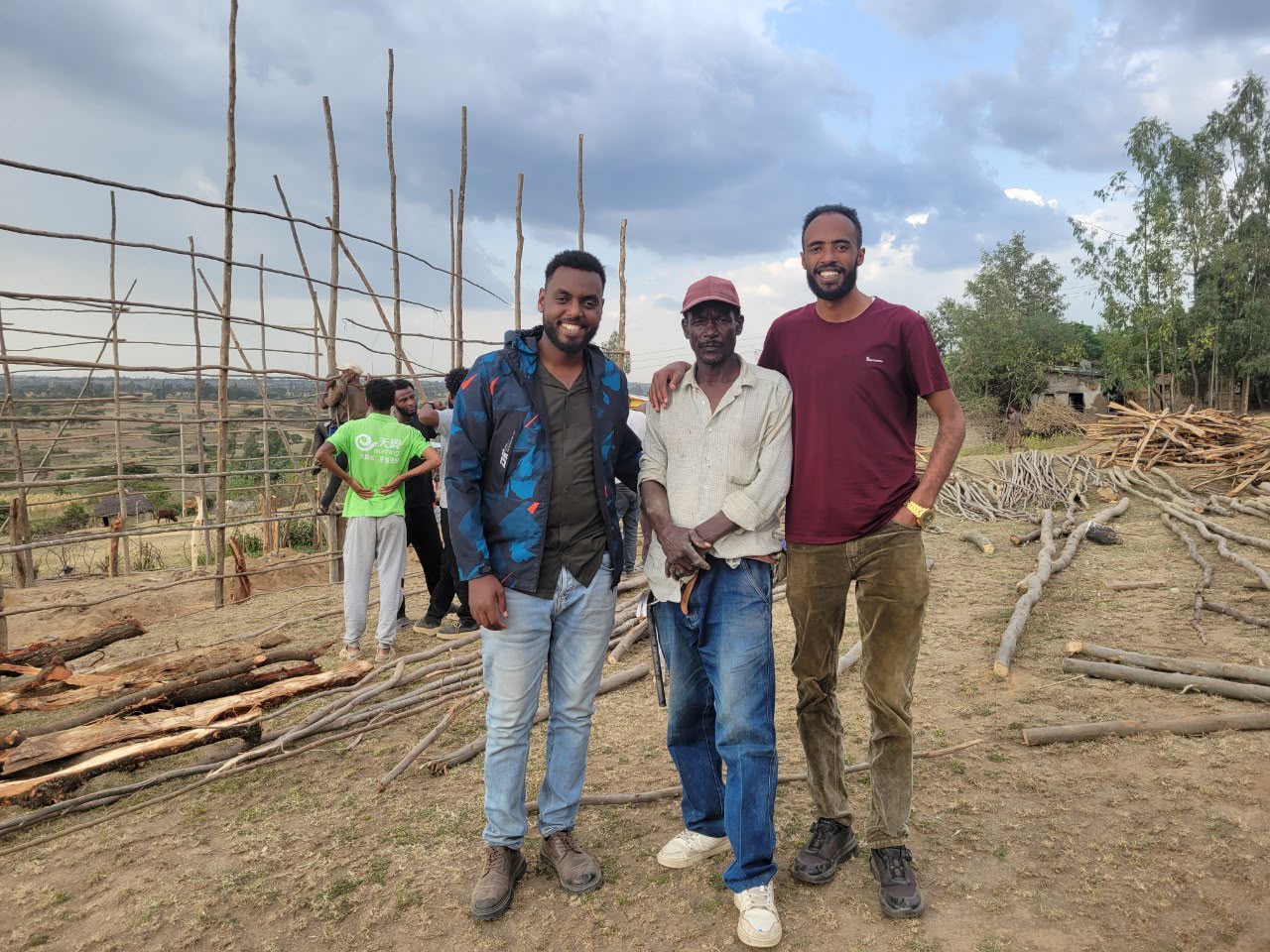 Three men standing together at the church building site